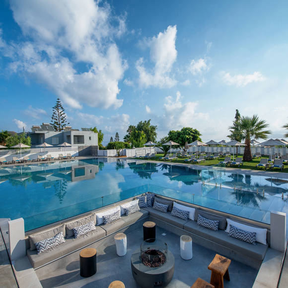 Outdoor lounge area with firepit by the pool 