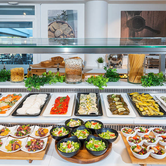 Buffet station with colorful cold dishes and appetizers