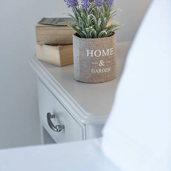 Decorative bedside table with lavender flowers and books
