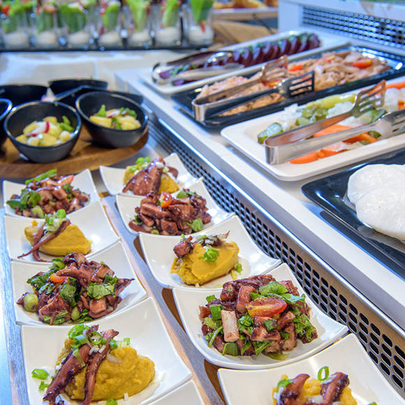 Buffet counter with gourmet seafood dishes and fresh salads at the hotel restaurant