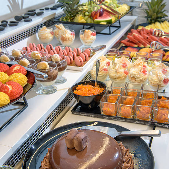Buffet counter with appetizing sweets and cakes at the hotel restaurant