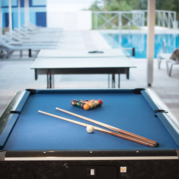Outdoor billiards and ping pong tables by the pool