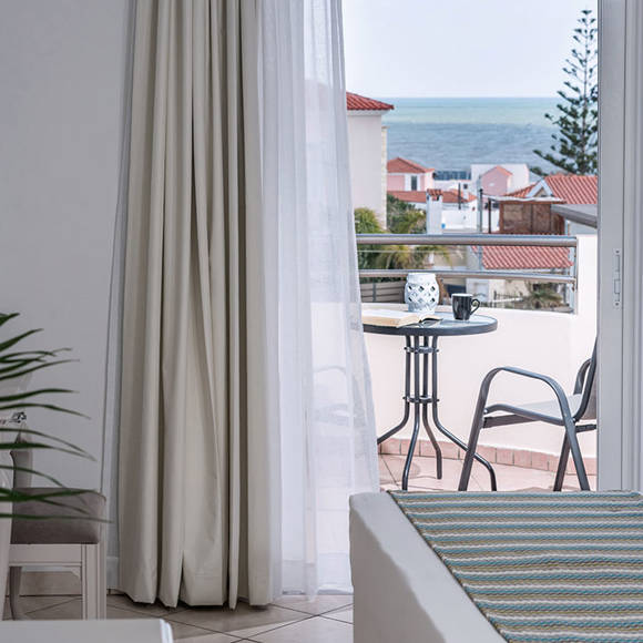 Private balcony with sea view, two chairs and a table